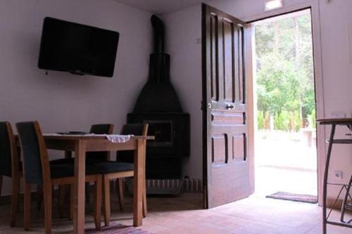 a dining room with a table and a fireplace at Cal Mosqueta in Sant Llorenc de Morunys