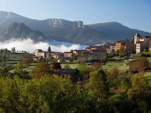 a view of a city with a town and a mountain at Cal Mosqueta in Sant Llorenc de Morunys