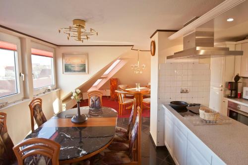 a kitchen with a table and a dining room at Ferienwohnung Geestemuende in Bremerhaven