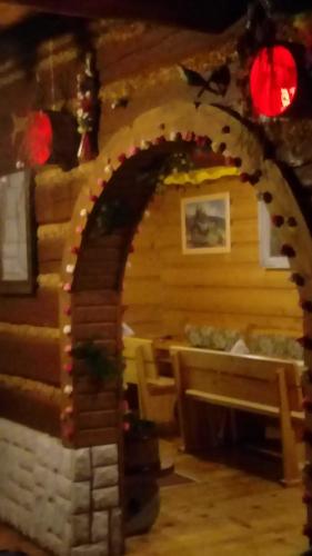 a gingerbread house with a fireplace in a room at Góralska Czarcia Chata pod Jałowcem in Stryszawa