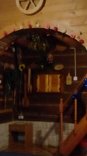 a wooden bench in a room with a clock on the wall at Góralska Czarcia Chata pod Jałowcem in Stryszawa