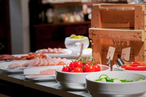 a table topped with bowls of vegetables and meats at Best Western Hotel Trollhattan in Trollhättan