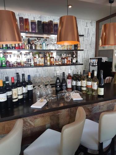 a bar with a bunch of bottles of wine at Apartmány Margo Sun Kamzík in Donovaly