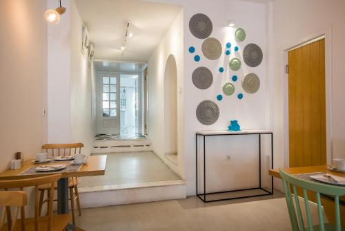 a dining room with a table and some plates on the wall at Argonauta Hotel in Parikia