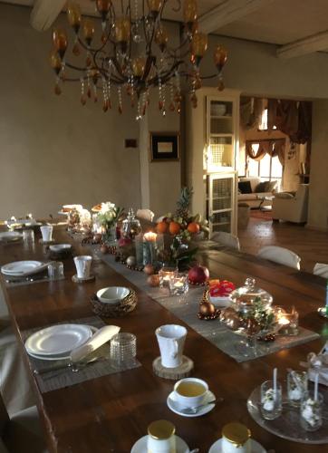 a dining room table with christmas decorations on it at Corte degli Angeli Agriturismo in Busseto