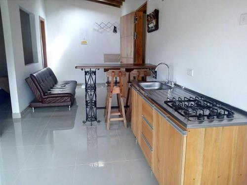a kitchen with a sink and a stove top oven at Jardín Amoblados in Jardin