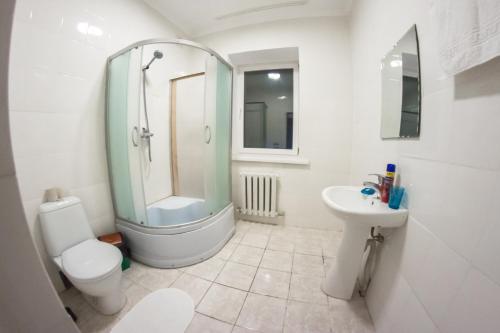 uma casa de banho com um chuveiro, um WC e um lavatório. em Guest House Palletto_borovoe em Borovoye