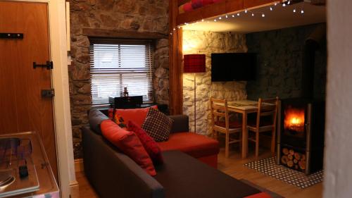 a living room with a couch and a table at The Bake House in Llangennith