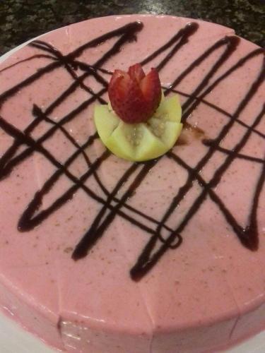 a pink cake with a strawberry on top of it at Excelaris Grand Resort Conventions & Spa in Tequesquitengo