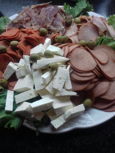a plate of food with meat and vegetables on it at Excelaris Grand Resort Conventions & Spa in Tequesquitengo