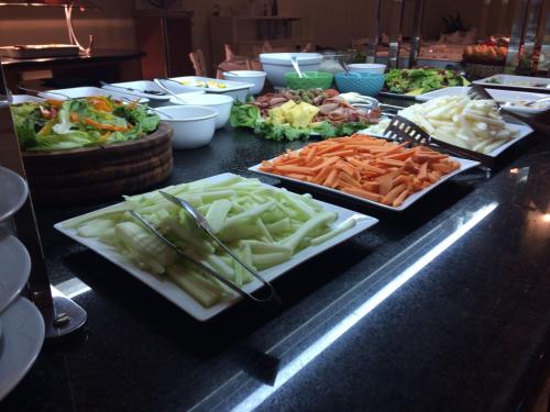 a buffet with many different types of vegetables on a counter at Excelaris Grand Resort Conventions & Spa in Tequesquitengo