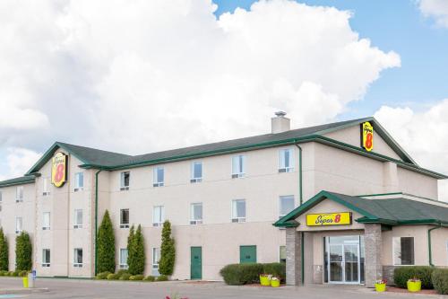 a hotel building with a fast food restaurant at Super 8 by Wyndham Prince Albert in Prince Albert