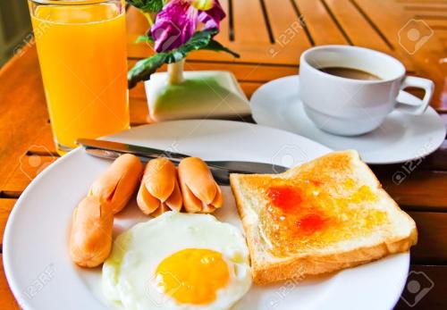 un plato de desayuno con un huevo y una tostada y una taza de café en Petrovskaya Pristan, en Cholpon-Ata