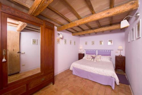 1 dormitorio con cama y techo de madera en Agriturismo Serpanera, en Sarnano