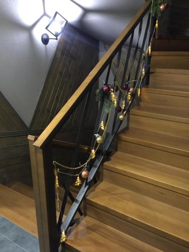 a staircase decorated for christmas with ornaments at Girske Povitria 2 in Yaremche