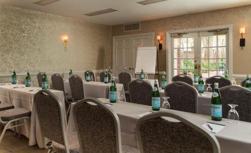 a conference room with tables and chairs with wine bottles at Linden Row Inn in Richmond