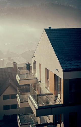 a building with glass balconies on top of it at Apartamenty Willowa in Szczyrk