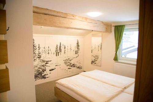a room with a bed with a picture on the wall at Haus Filzmoos in Filzmoos