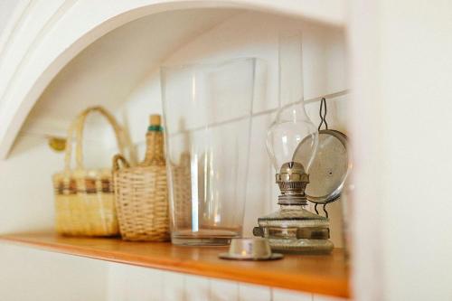 a shelf with bottles and glasses and baskets on it at Time To Experience in Salobre
