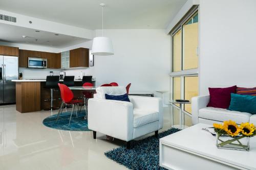 a living room with a white couch and a table at Blue Residences in Palm-Eagle Beach