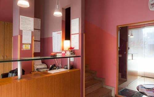 an office with a desk and a phone on a wall at Hotel Albi in Stezzano