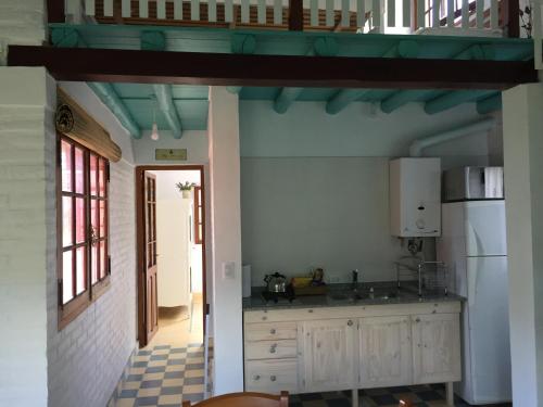 a kitchen with a sink and a refrigerator at Raco De La Calma in Nono