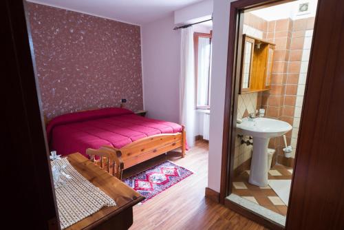 a bathroom with a bed and a sink and a mirror at Agriturismo Falode in Castello del Matese
