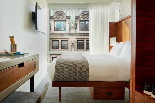 a hotel room with a bed and a window at Arlo NoMad in New York