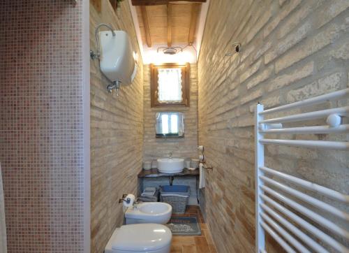 a bathroom with two toilets and a sink at Casale del Monsignore in Spoleto