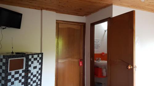 a bathroom with a door and a sink in a room at Alojamiento Rural Bellavista in Filandia