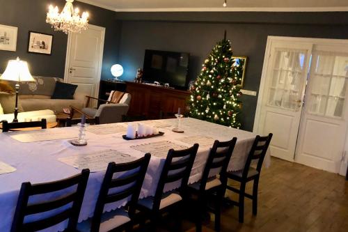 a living room with a table and a christmas tree at The White House in Reykholt
