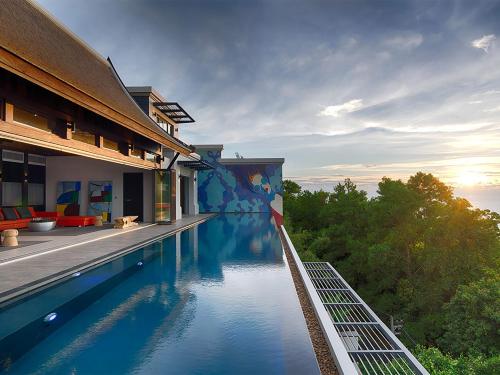 a swimming pool on the side of a building at Malaiwana Villas in Nai Thon Beach