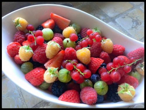 a white bowl filled with lots of fruits and vegetables at Le Mas de Mougins in Mougins