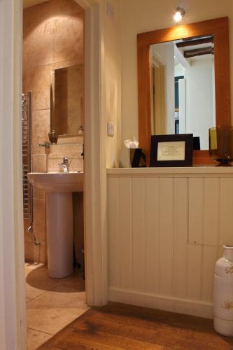 a bathroom with a sink and a mirror at Mason's Arms in Bowland Bridge