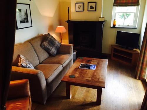 a living room with a couch and a coffee table at Mason's Arms in Bowland Bridge