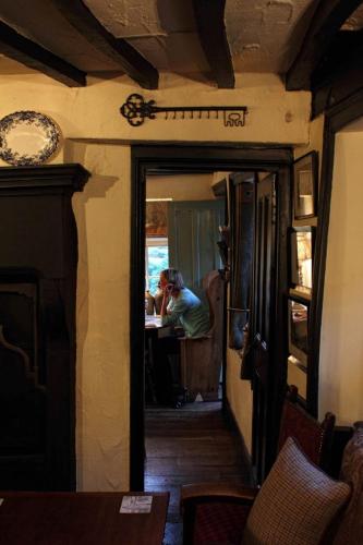 a person sitting at a table in a room at Mason's Arms in Bowland Bridge