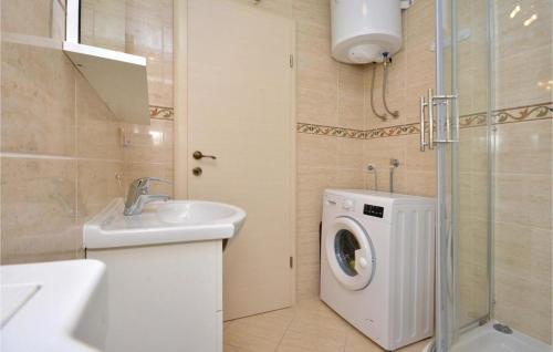 a bathroom with a washing machine and a sink at Ani Apartments in Kaštela
