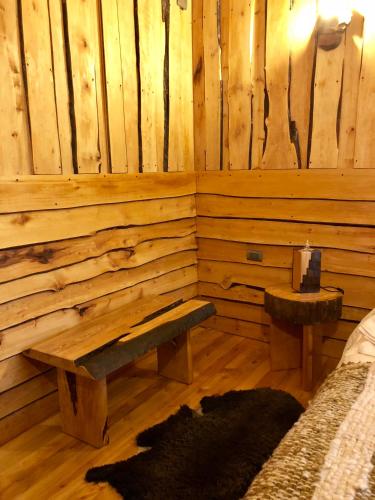 a log cabin with a bench and a table at Terrazas altos de Gamboa in Castro