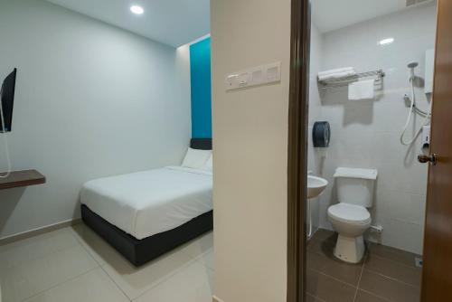 a small bathroom with a bed and a toilet at G3 HOUSE in Johor Bahru