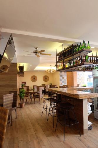 a restaurant with a bar with tables and chairs at The Piccolo Hotel of Boracay in Boracay