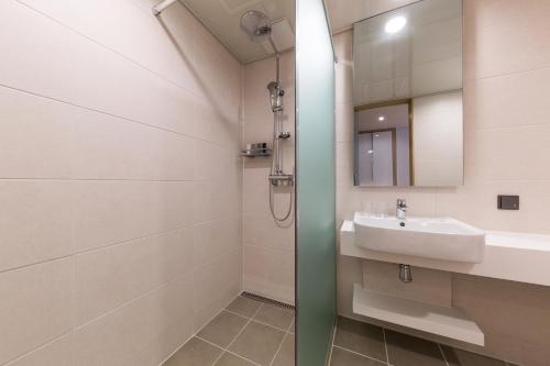a bathroom with a sink and a mirror at Days Hotel & Suites by Wyndham Incheon Airport in Incheon