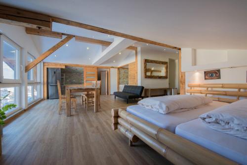 a bedroom with two beds and a dining room with a table at Schlafmeile Traunsee in Ebensee