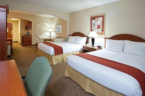 a hotel room with two beds and a desk at Holiday Inn Express Hotel & Suites Erie-Summit Township, an IHG Hotel in Erie