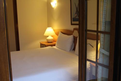 a bedroom with a bed and a lamp on a table at Efe Hotel Gocek in Göcek