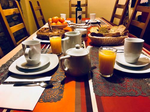 a table with food and drinks on a table with a table cloth at Argonz Etxea in Urzainqui