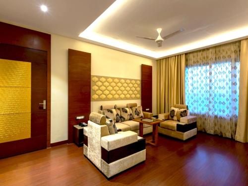a living room with a couch and two chairs at Hotel Kasturi Orchid in Pāl
