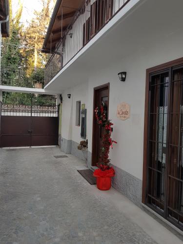 a building with a door and a plant in a pot at La Corte B&B in Candiolo
