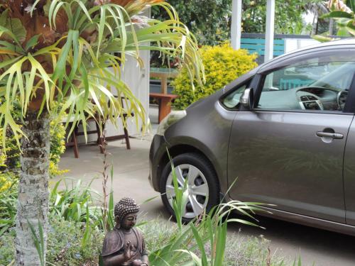 a car parked next to a statue next to a car at Channers on Norfolk in Burnt Pine