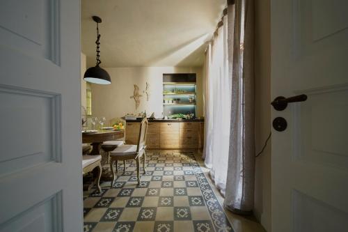 a kitchen with a table and a dining room at Ferrini Home - Piazza Trento in Catania
