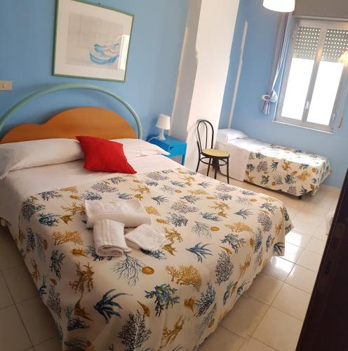 Кровать или кровати в номере Hotel Ristorante La Scogliera - NUOVA GESTIONE